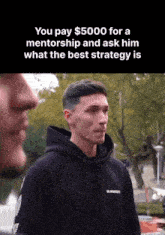 a man wearing a burberry hoodie is talking to another man