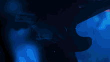 a blurry picture of a person playing a keyboard in a blue room