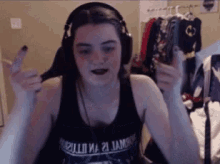 a girl wearing headphones and a tank top that says ' molecule 21 '