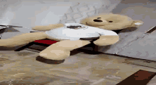 a teddy bear wearing a white shirt with a picture of a man on it