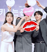 a group of people holding up signs with sbs written on them