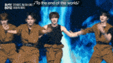 a group of young men are dancing in front of a blue background and the words " to the end of the world " are above them