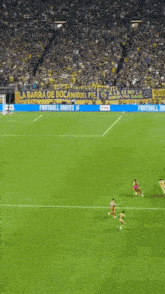 a soccer field with a banner that says la barra de boca miguel