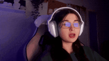 a woman wearing glasses and headphones has a sticker on her glasses that says ' netflix ' on it