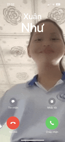 a girl is talking on a phone with xuan nhu on the screen