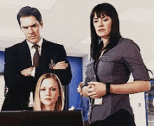 a man in a suit and tie is standing next to two women