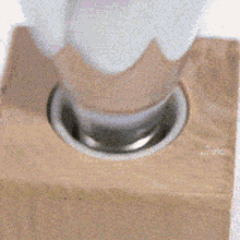 a light bulb is sitting in a wooden block