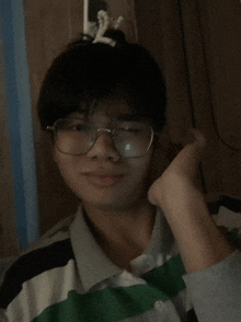 a person wearing glasses and a striped shirt