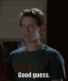 a man wearing a blue shirt that says good guess