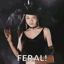 a girl in a witch costume is holding a light and the word feral is above her