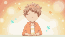 a little boy with his eyes closed and flowers behind him