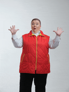 a woman wearing a red vest with the word columbia on the front