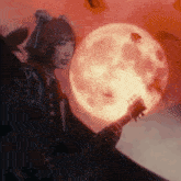 a woman playing a guitar with a full moon in the background
