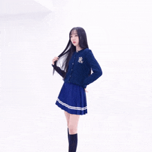 a girl wearing a blue sweater with the letter r on the front