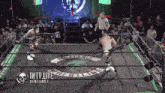 two wrestlers in a wrestling ring with the words iwtv live written on the bottom