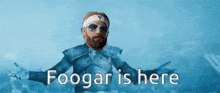a man with a beard wearing sunglasses and a headband with the words foogar is here