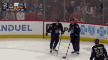a hockey game is being played in front of an ad for induel