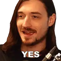 a man with long hair and a beard is holding a microphone and says yes