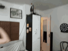 a room with a dart board on the wall and a picture on the wall