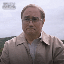a man wearing glasses and a jacket with the words son of a glitch on the bottom right