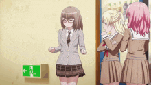 a girl in a school uniform is standing in front of a green exit sign