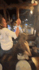 a group of people are dancing in a room with a window in the background