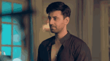 a man in a black shirt without a shirt on