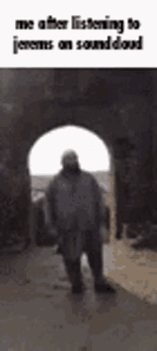 a man is standing in the middle of a tunnel while listening to a song on soundcloud .