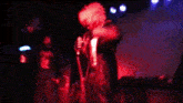 a blurry image of a person dancing in a dark room