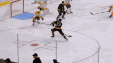 a hockey game is being played in front of a sunrise advertisement