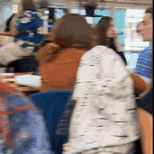 a blurry picture of people sitting in a restaurant with the words margentos gif at the top
