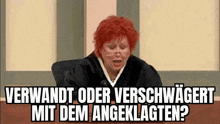 a judge with red hair is sitting in a courtroom and talking into a microphone .