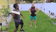 a man wearing a tank top that says lrlr is standing in the grass