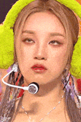 a close up of a woman wearing a microphone and headphones