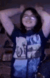 a girl wearing a blue shirt with the word off on it is dancing