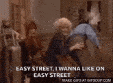a group of people are dancing in a room with a man holding a microphone .