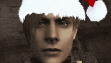 a man wearing a santa hat is looking at the camera