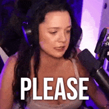 a woman wearing headphones is sitting in front of a microphone and saying please