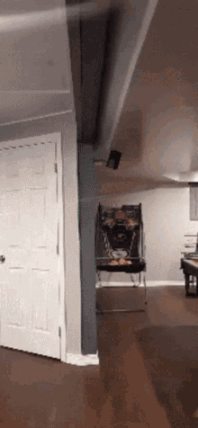 a room with a pinball machine on the wall