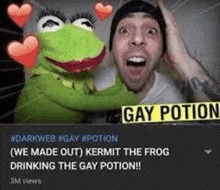 a man is hugging a kermit the frog puppet with hearts around his head .
