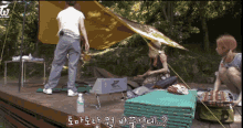 a person standing in front of a tent with the letter w on the top