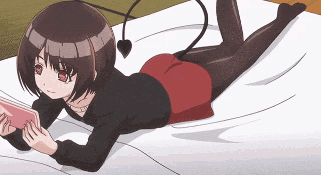 a girl with a tail is laying on a bed playing a game