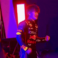 a man in a blue red bull suit is flexing his muscles