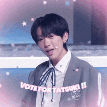 a young man in a suit and tie says vote for tatsuki !!