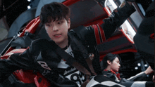 a young man wearing a jacket with the number 93 on it
