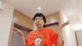 a woman is wearing a red shirt that says turn up the music