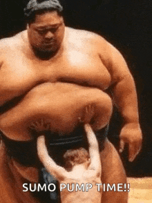a sumo wrestler is pumping a small child 's breast .