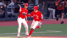 two blue jays players celebrate a home run on the field