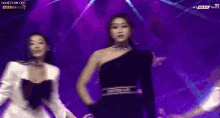 two women are dancing on a stage with the words honeycam.org at the top
