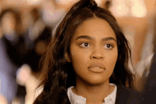 a close up of a young woman 's face with a ponytail